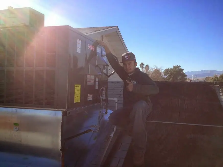 HVAC technician performing AC Tune-Up on a rooftop unit in Lincoln Park